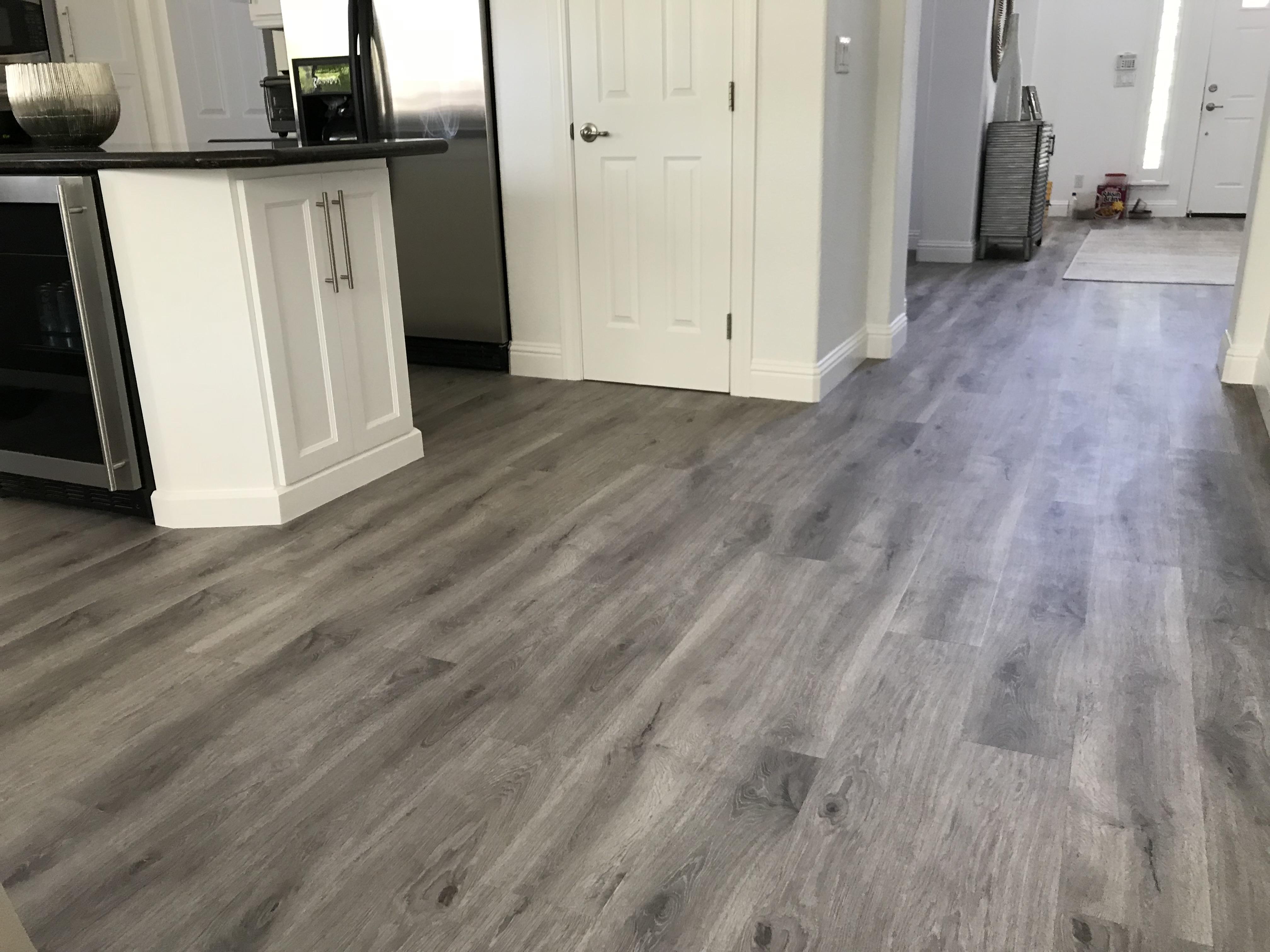 Gray laminate flooring through kitchen and entryway in a Fair Oaks, CA home
