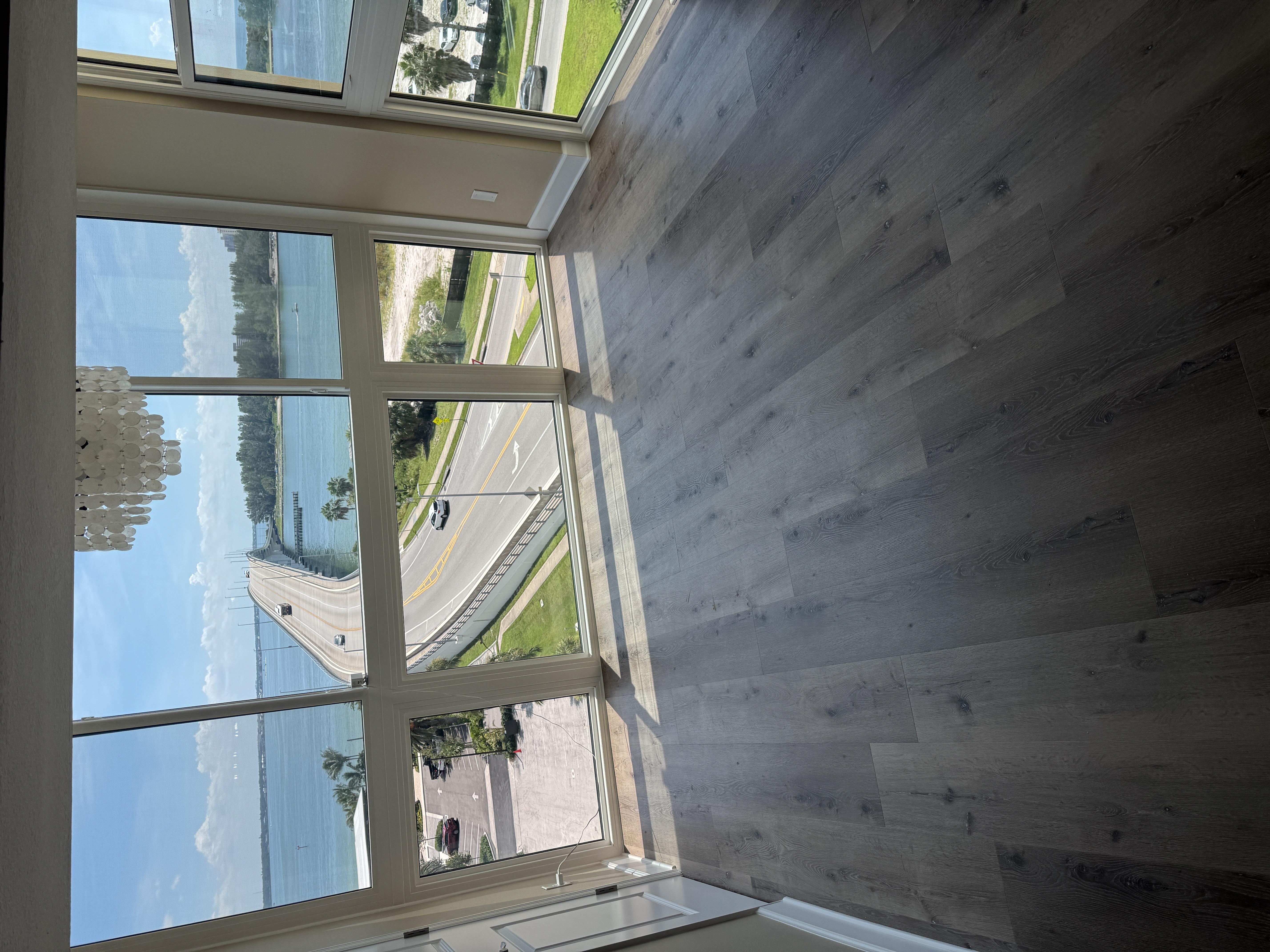 Light oak vinyl plank flooring in a high-rise condo living room in a North Highlands, CA home