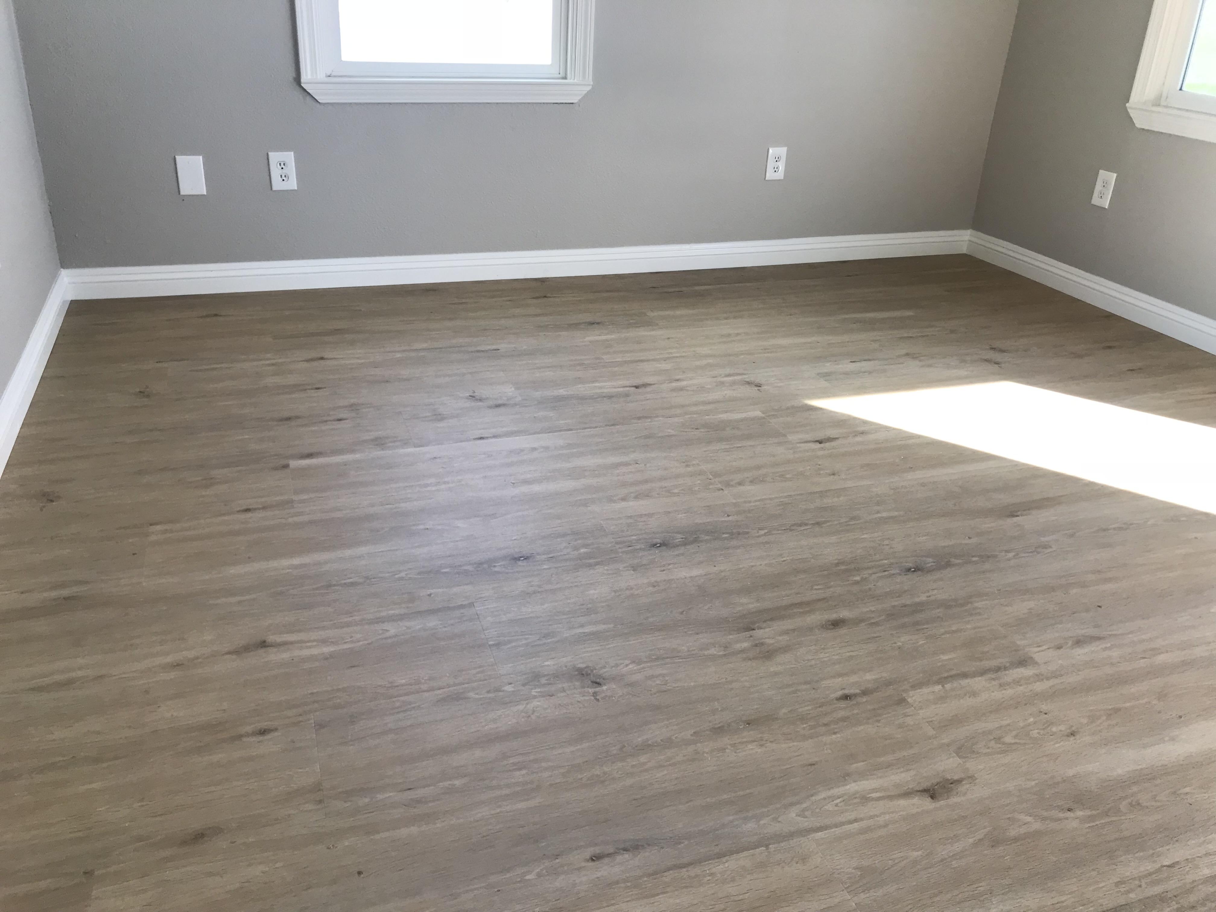Light wide-plank luxury vinyl bedroom floor in a Carmichael, CA home
